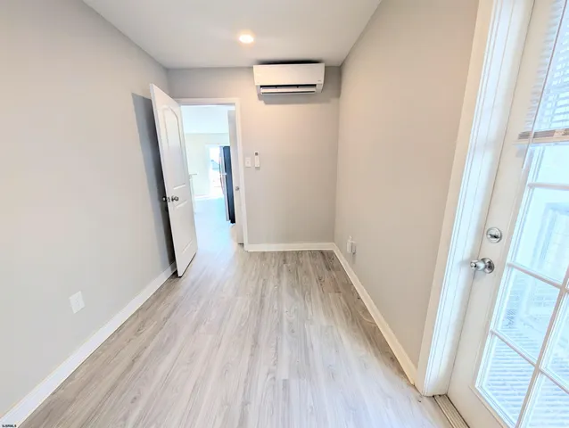 a view of a hallway view with wooden floor and staircase