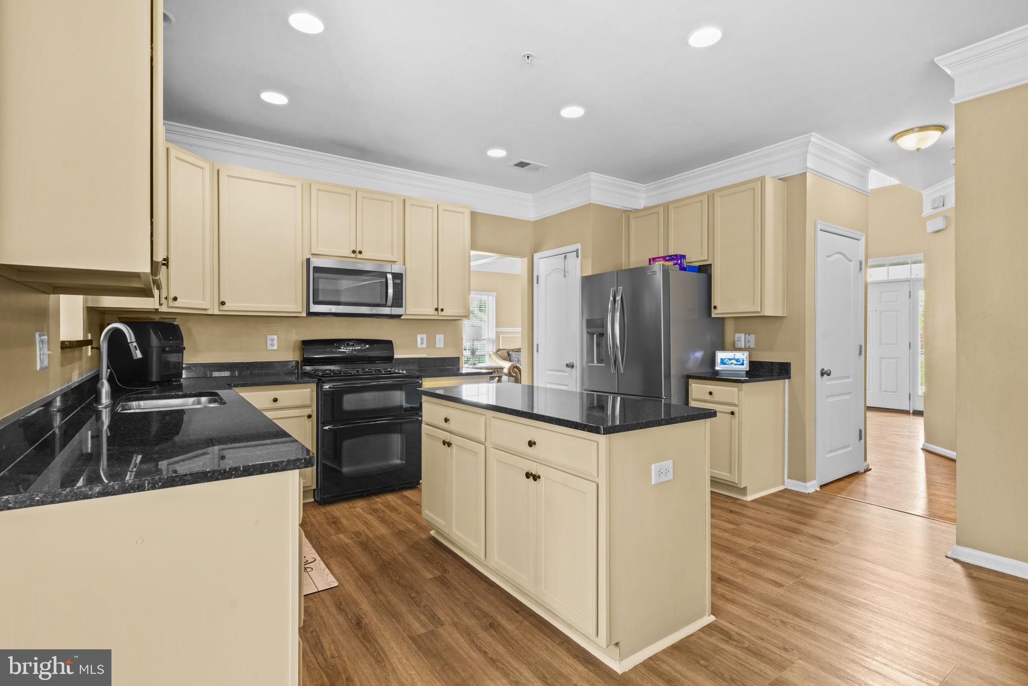1507 St Albans Lane Accokeek, MD 20607 - Photo 16 of 36 a kitchen with granite countertop a refrigerator stove and sink