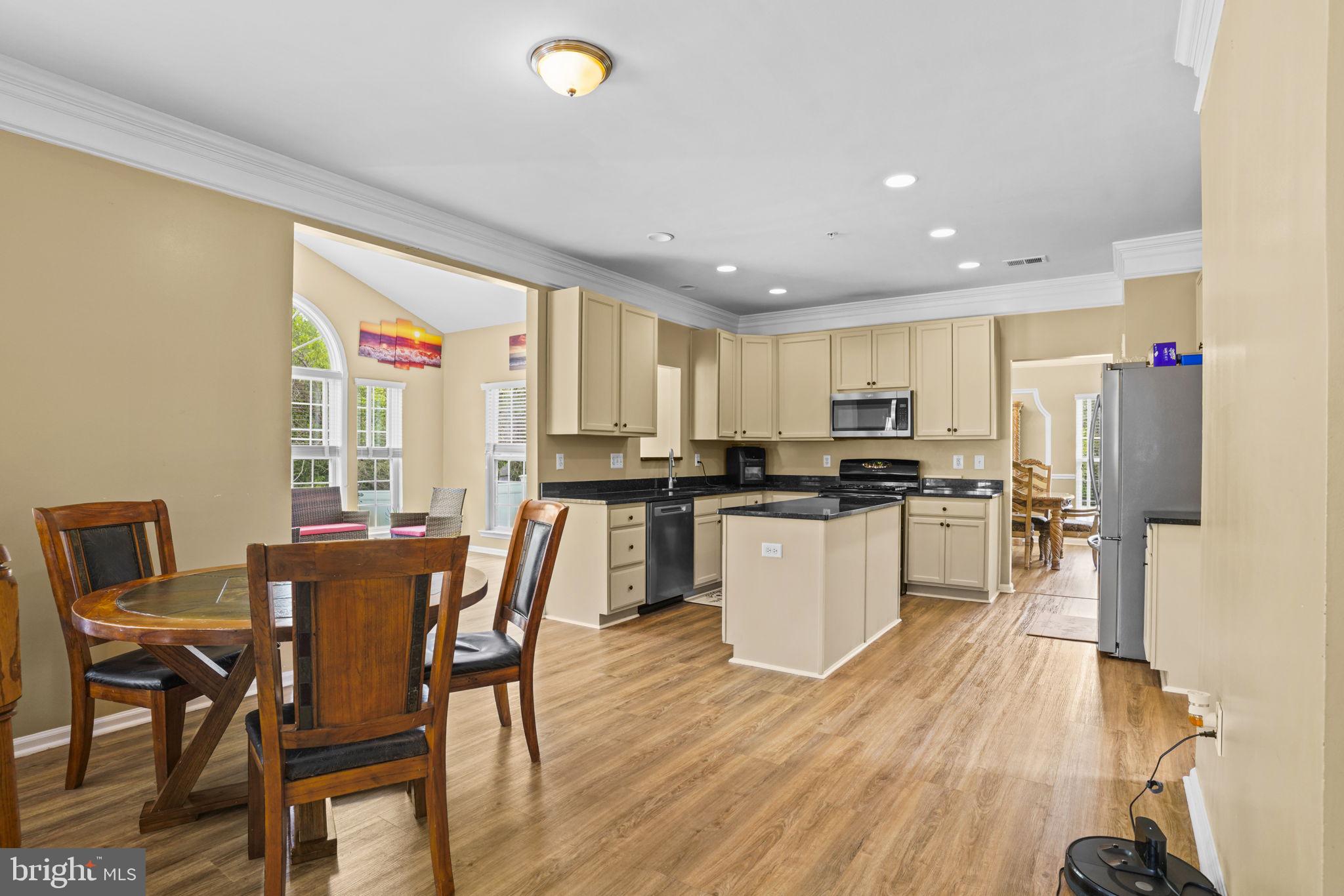 1507 St Albans Lane Accokeek, MD 20607 - Photo 21 of 36 a kitchen with a table chairs refrigerator and cabinets