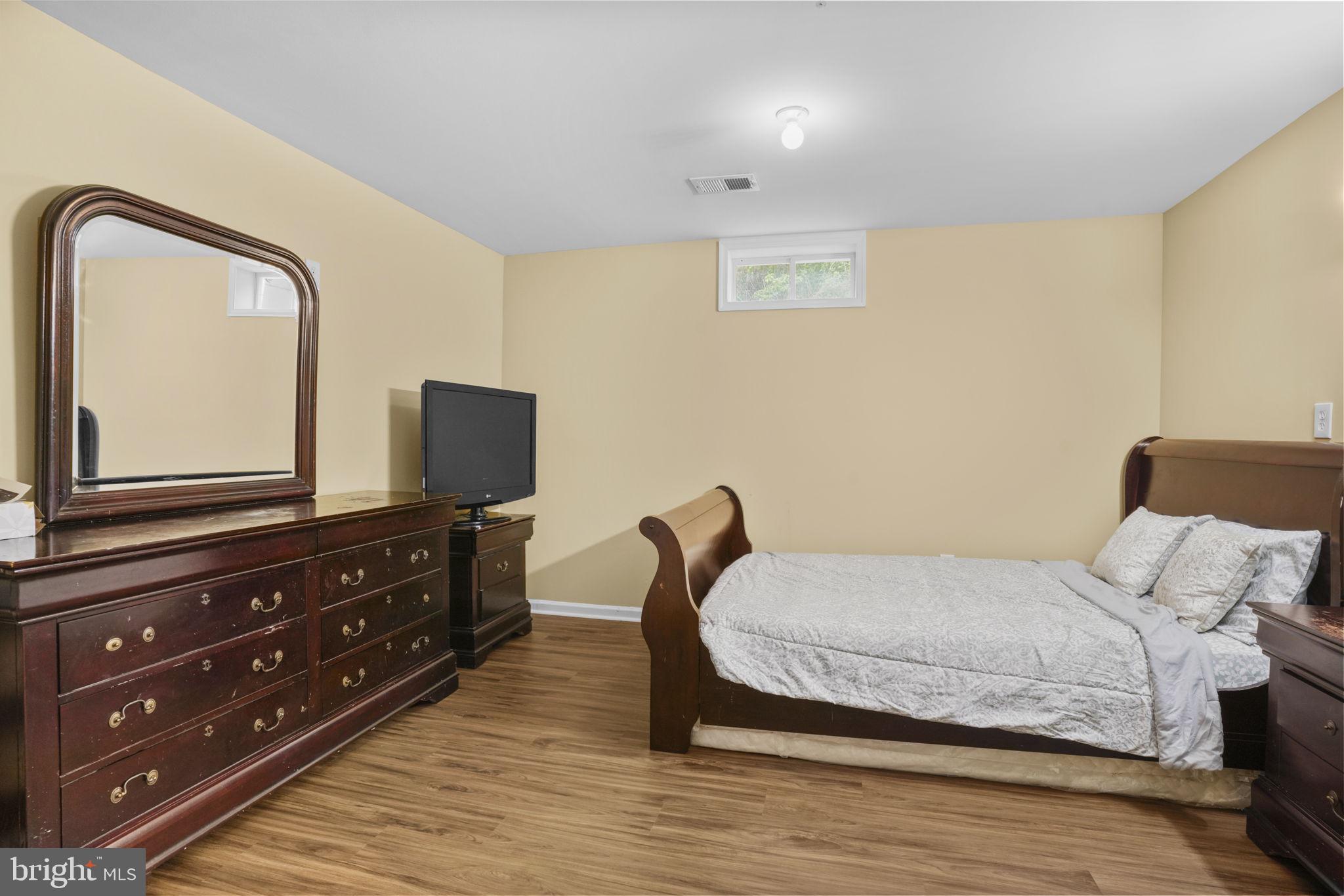 1507 St Albans Lane Accokeek, MD 20607 - Photo 28 of 36 a bedroom with a bed and a flat screen tv