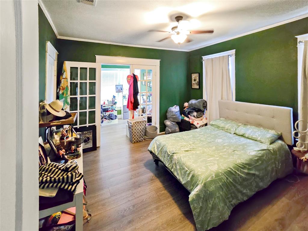 502 Griffith Avenue Terrell, TX 75160 - Photo 12 of 25 a bedroom with a bed and wooden floor