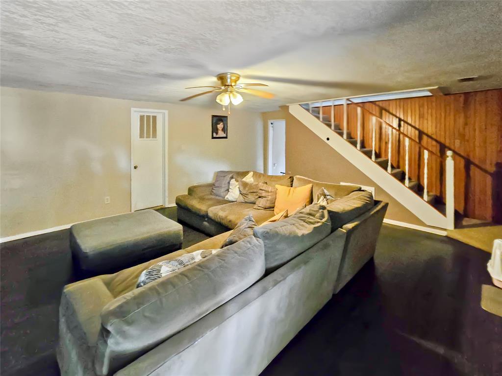 502 Griffith Avenue Terrell, TX 75160 - Photo 20 of 25 a view of a living room with furniture and stairs