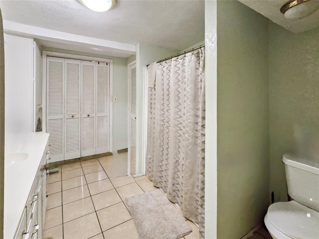 502 Griffith Avenue Terrell, TX 75160 - Photo 23 of 25 a bathroom with a shower and a toilet