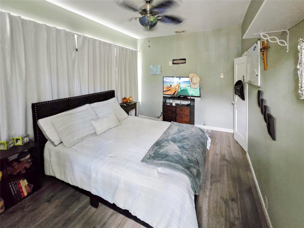 502 Griffith Avenue Terrell, TX 75160 - Photo 9 of 25 a bedroom with a bed and a chandelier