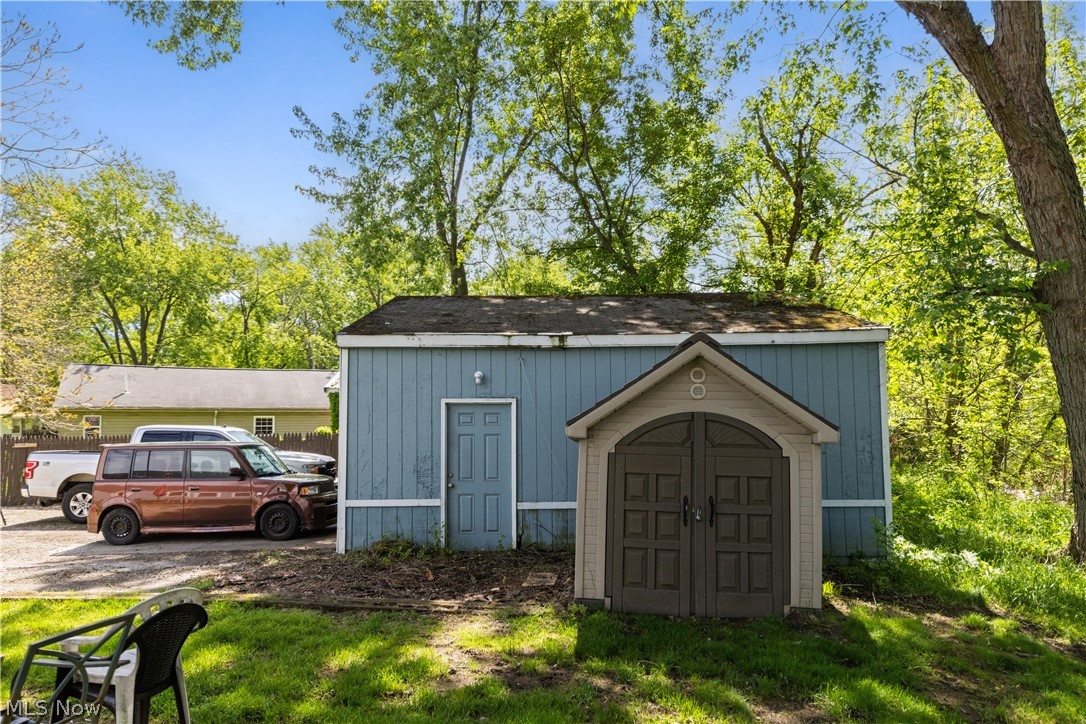 68-70 East Sunset Drive Rittman, OH 44270 - Photo 48 of 49 Light blue storage shed featuring a single entry door and an additional smaller brown storage unit