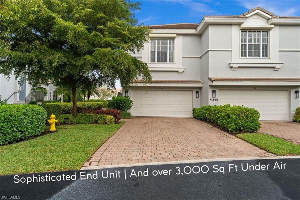 5045 Blauvelt Way, Unit 201 Naples, FL 34105 - Photo 1 of 39 a front view of a house with a yard