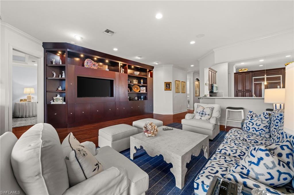5045 Blauvelt Way, Unit 201 Naples, FL 34105 - Photo 11 of 39 a living room with furniture and a flat screen tv