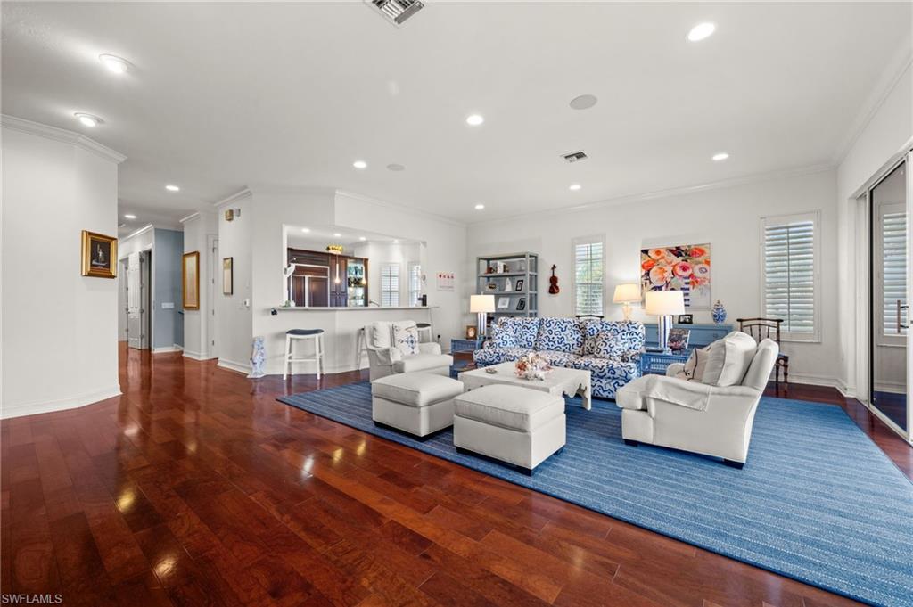 5045 Blauvelt Way, Unit 201 Naples, FL 34105 - Photo 13 of 39 a living room with furniture and a wooden floor