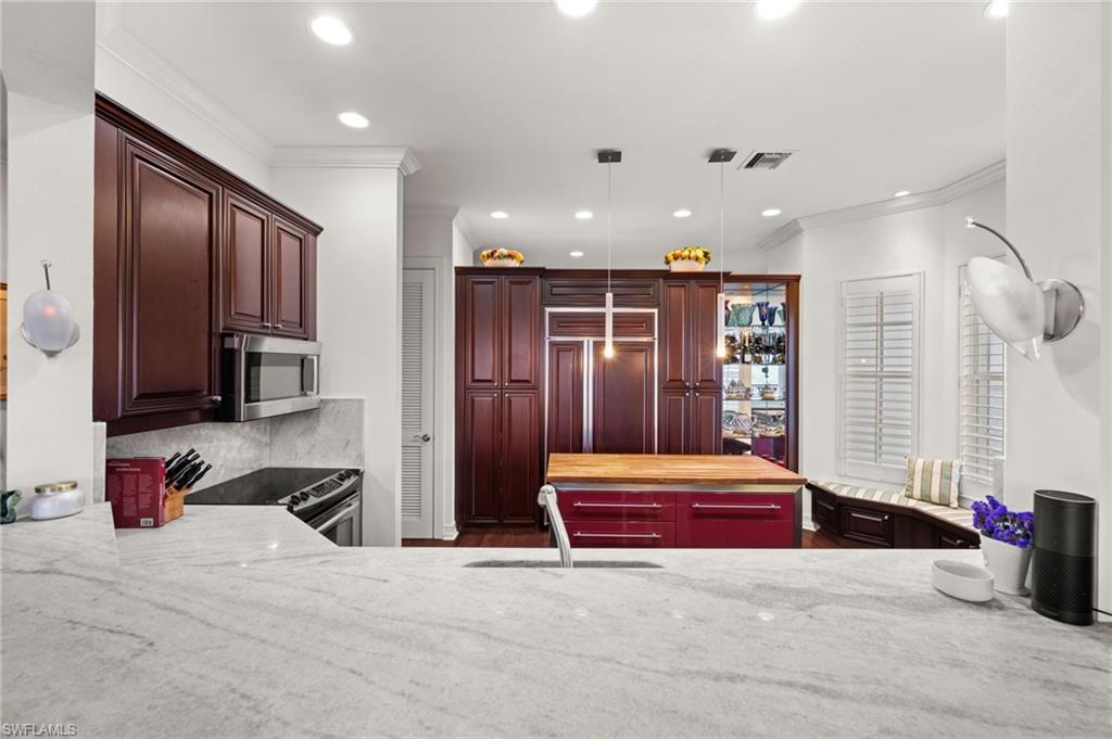 5045 Blauvelt Way, Unit 201 Naples, FL 34105 - Photo 15 of 39 a bedroom with a bed and dresser