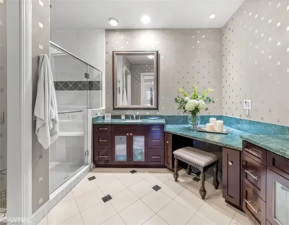5045 Blauvelt Way, Unit 201 Naples, FL 34105 - Photo 24 of 39 a bathroom with a granite countertop sink a mirror and a shower