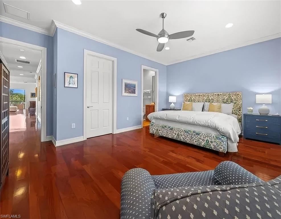 5045 Blauvelt Way, Unit 201 Naples, FL 34105 - Photo 30 of 39 a bedroom with a bed ceiling fan and a rug