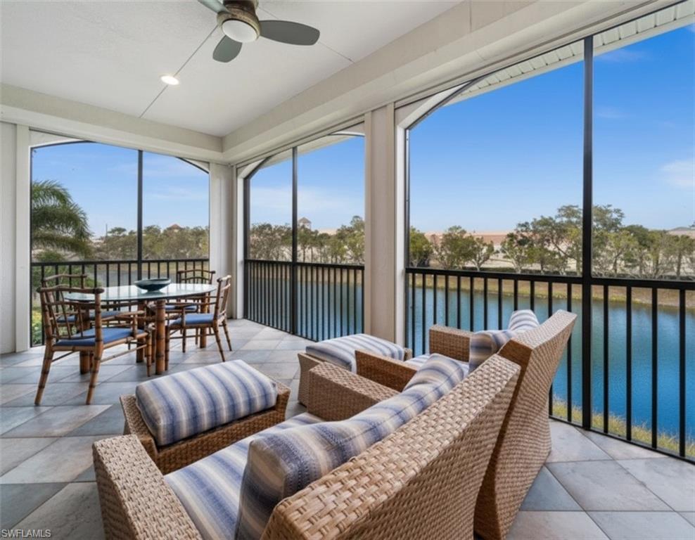 5045 Blauvelt Way, Unit 201 Naples, FL 34105 - Photo 5 of 39 a balcony with furniture and a floor to ceiling window