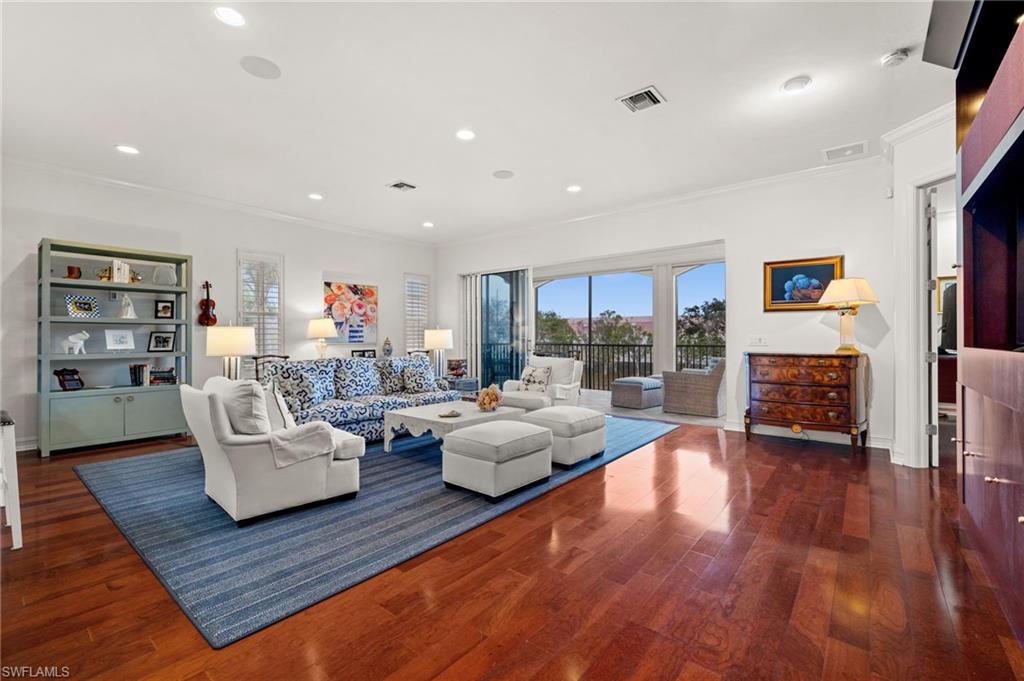 5045 Blauvelt Way, Unit 201 Naples, FL 34105 - Photo 9 of 39 a living room with furniture or couch and a fireplace
