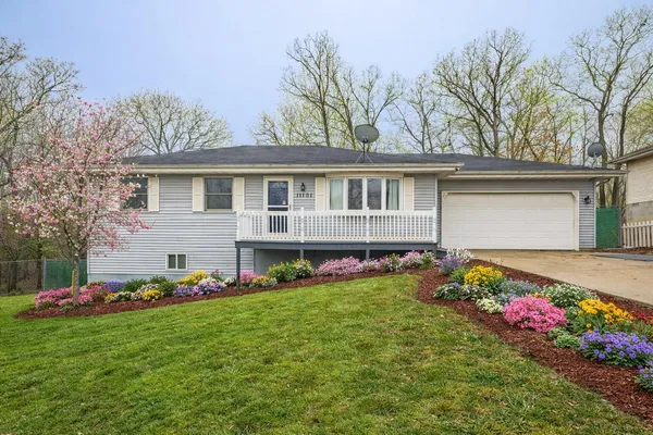 a front view of house with yard and outdoor seating