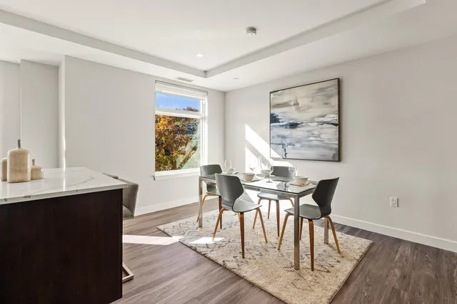 a view of a dining room with furniture window and wooden floor