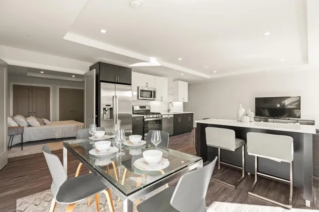 a kitchen with stainless steel appliances a sink a stove and microwave