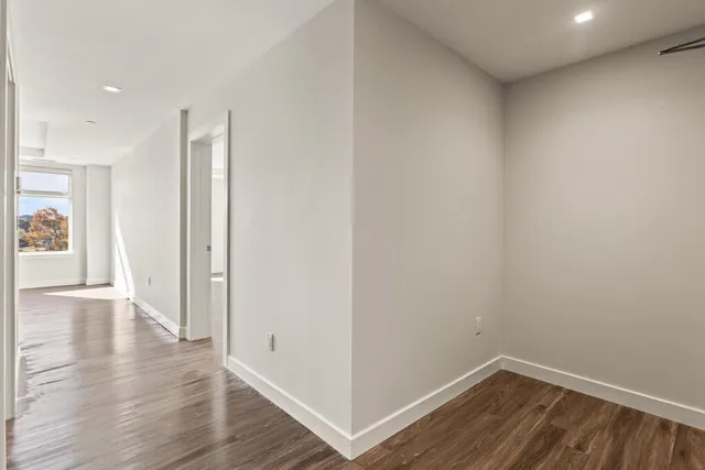 a bedroom with a bed and a night stand