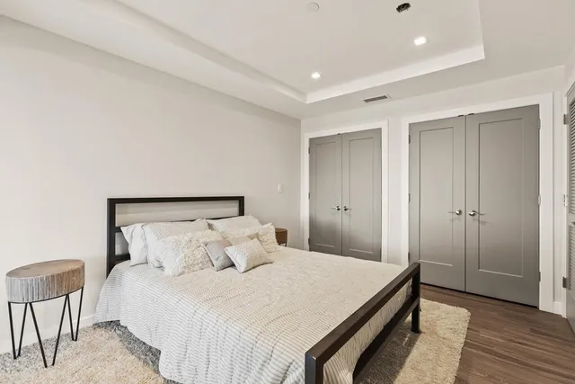 a bedroom with a large bed and a window