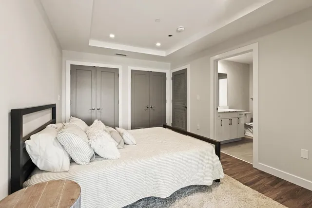 an empty room with wooden floor and window