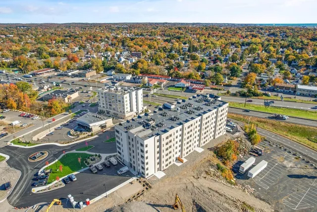 an aerial view of residential building and lake