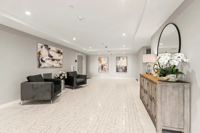a living room with furniture and a painting on the wall