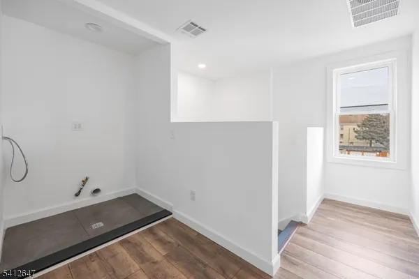 a view of a room with wooden floor and windows