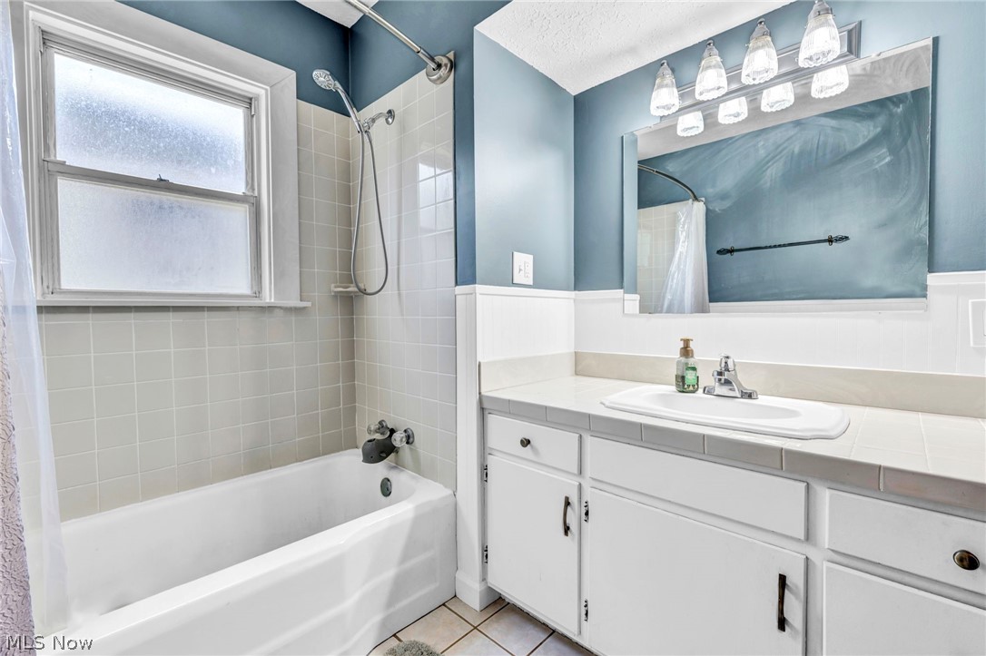 7983 Wadsworth Road Medina, OH 44256 - Photo 19 of 42 Bathroom with oversized vanity, shower / bath combination with curtain, and tile floors
