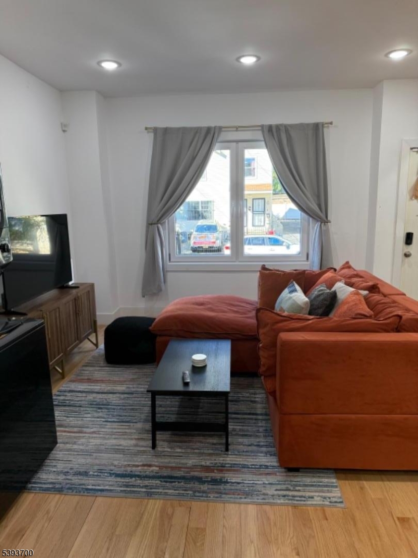492 South 20th Street Newark, NJ 07103 - Photo 5 of 13 a living room with furniture and a large window