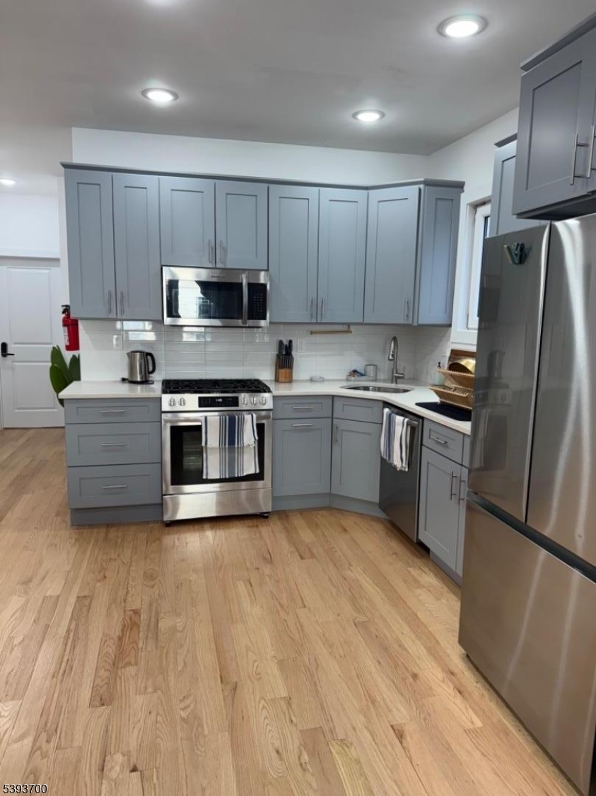492 South 20th Street Newark, NJ 07103 - Photo 6 of 13 a kitchen with stainless steel appliances granite countertop a refrigerator sink and cabinets