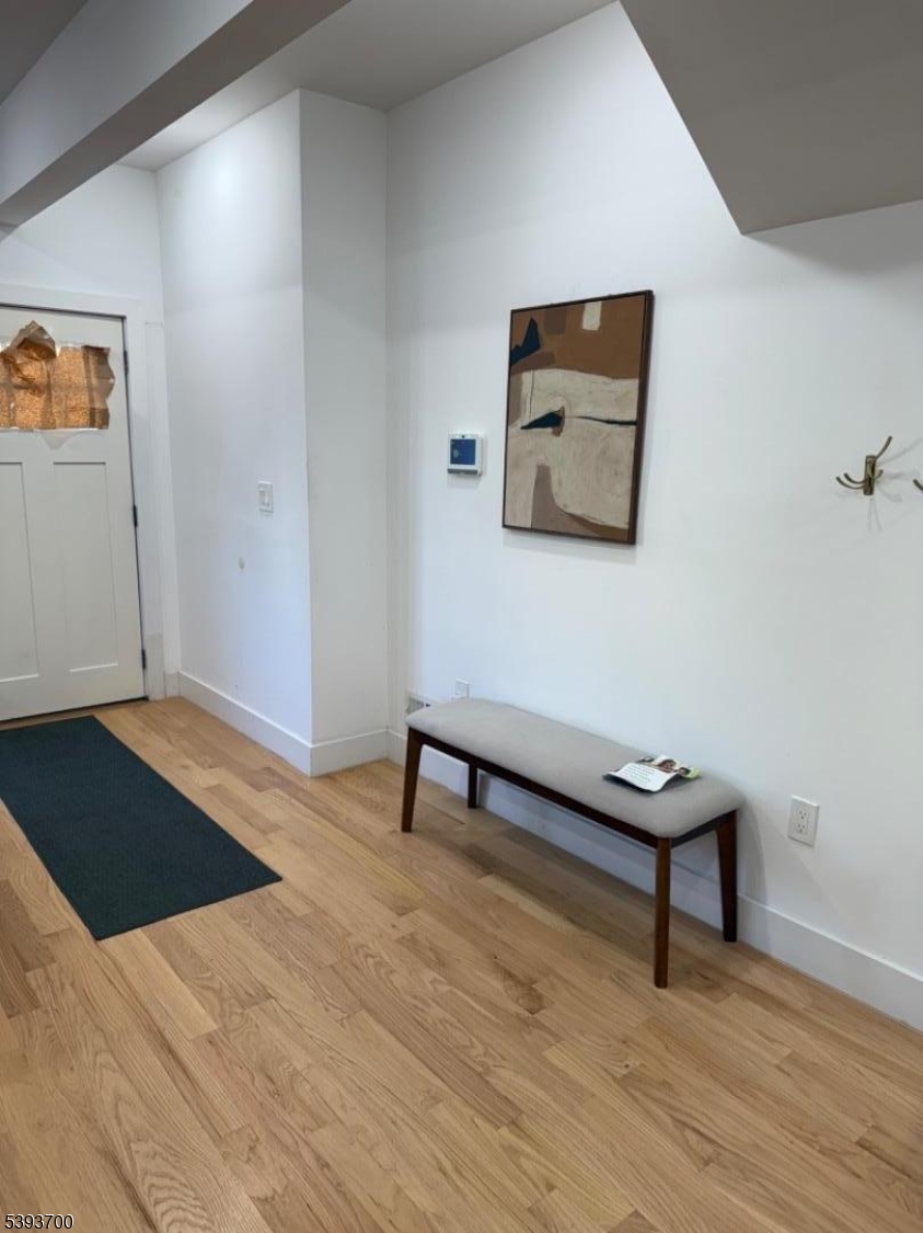 492 South 20th Street Newark, NJ 07103 - Photo 8 of 13 a hallway with a bench and a wooden floor