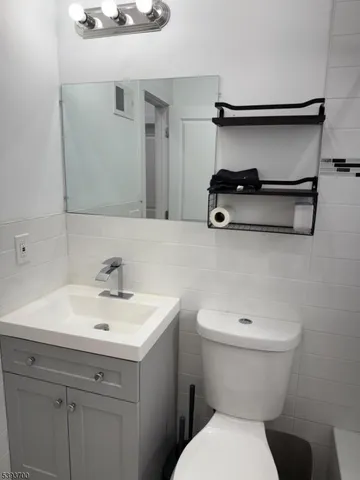 a bathroom with a sink toilet and vanity