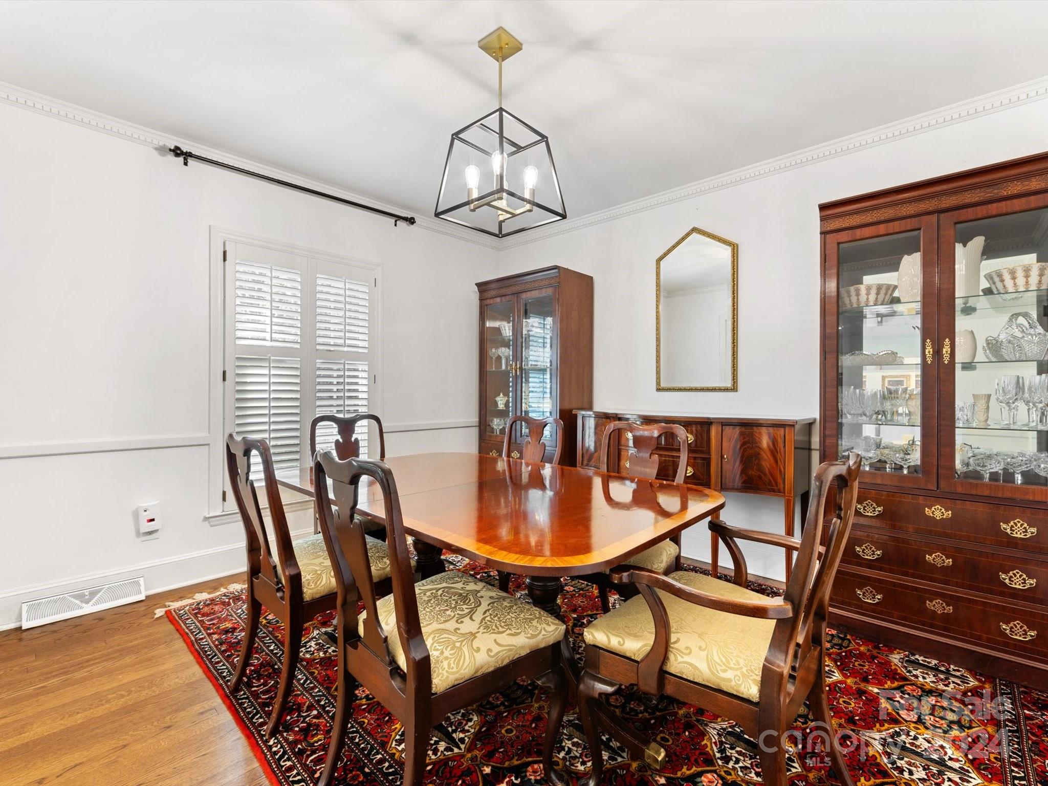 4233 Columbine Circle Charlotte, NC 28211 - Photo 13 of 47 a dining room with furniture a chandelier and wooden floor