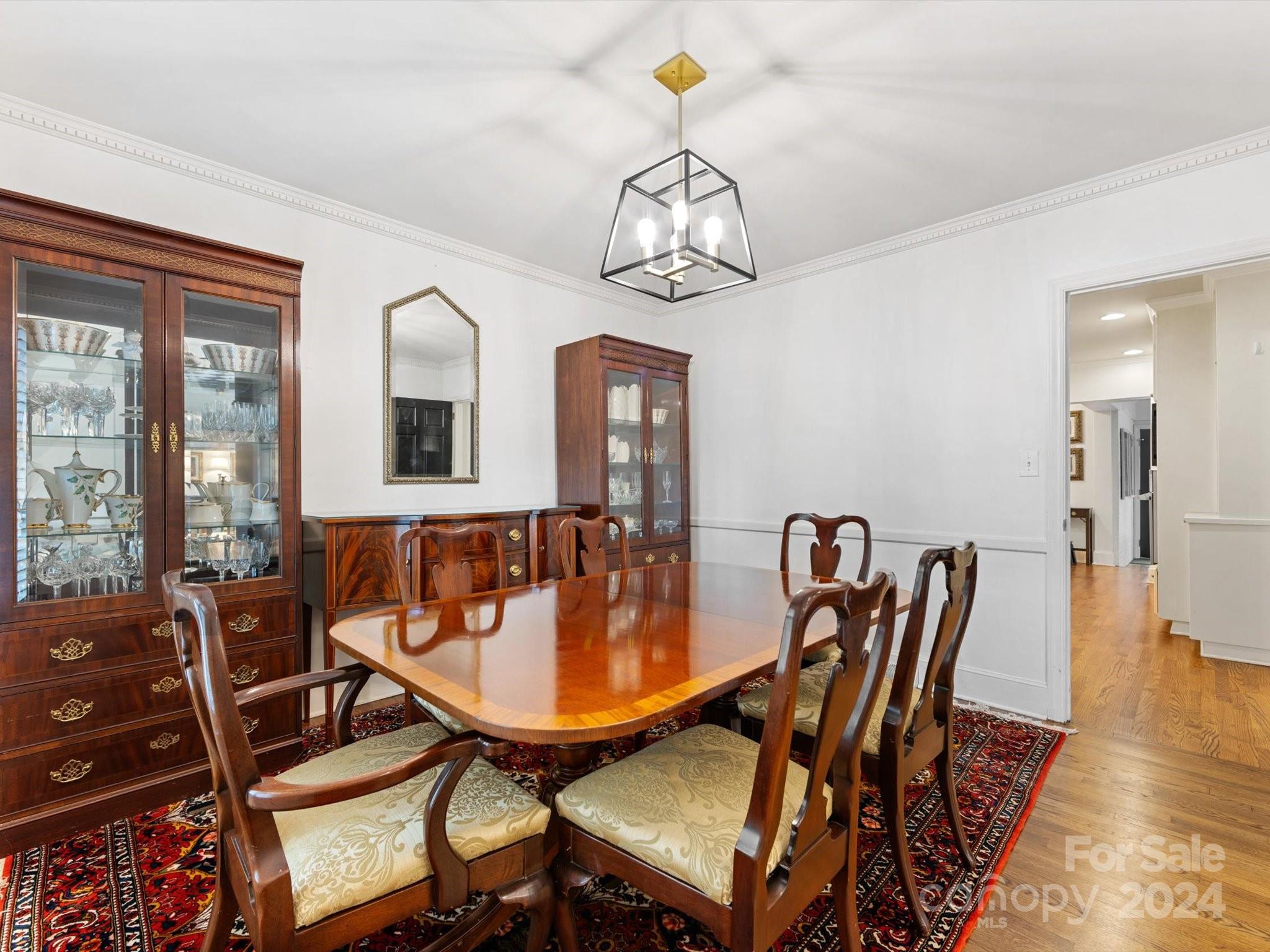 4233 Columbine Circle Charlotte, NC 28211 - Photo 14 of 47 a dining room with furniture a chandelier and wooden floor