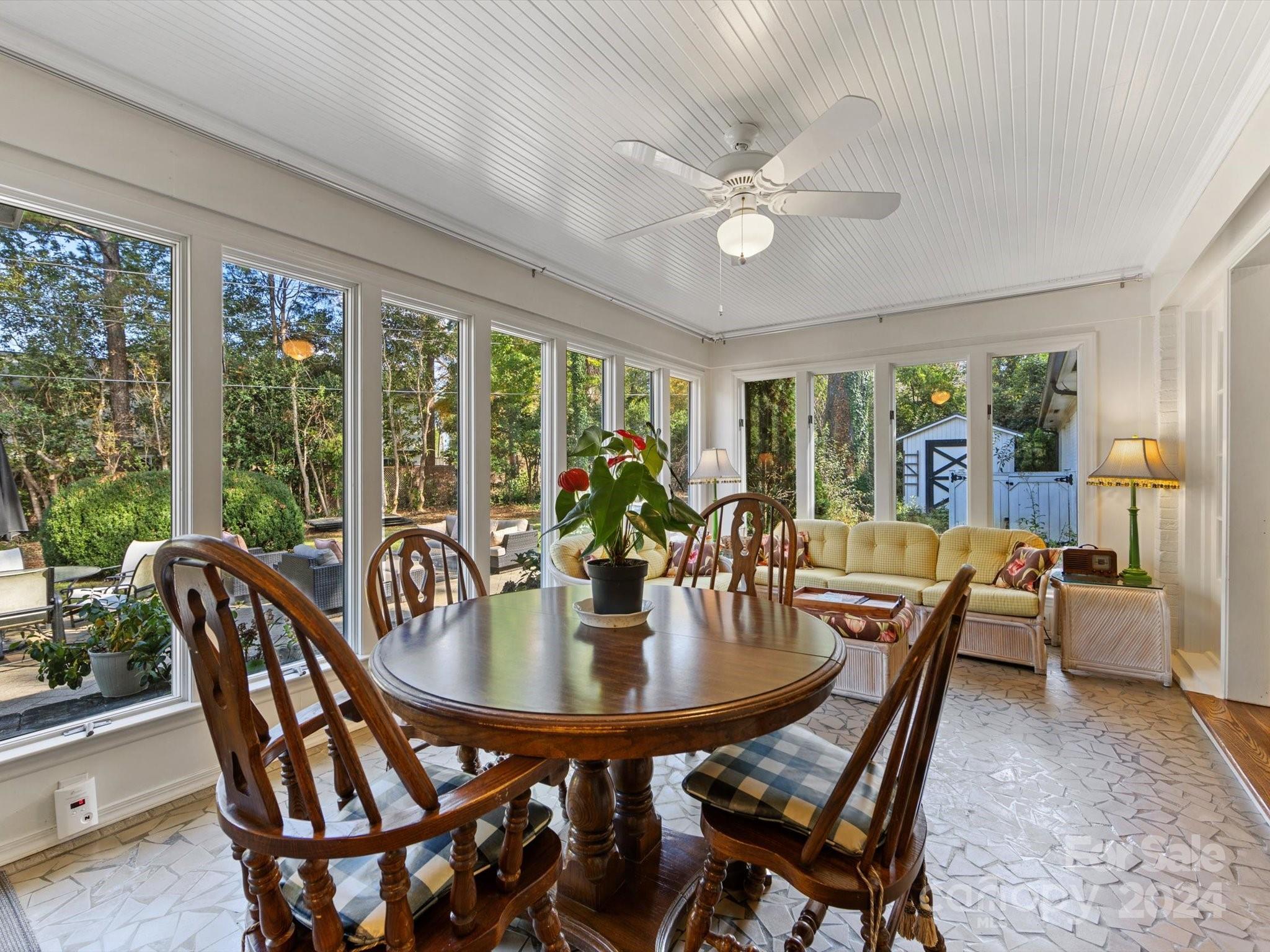 4233 Columbine Circle Charlotte, NC 28211 - Photo 19 of 47 a dining room with furniture wooden floor and a chandelier