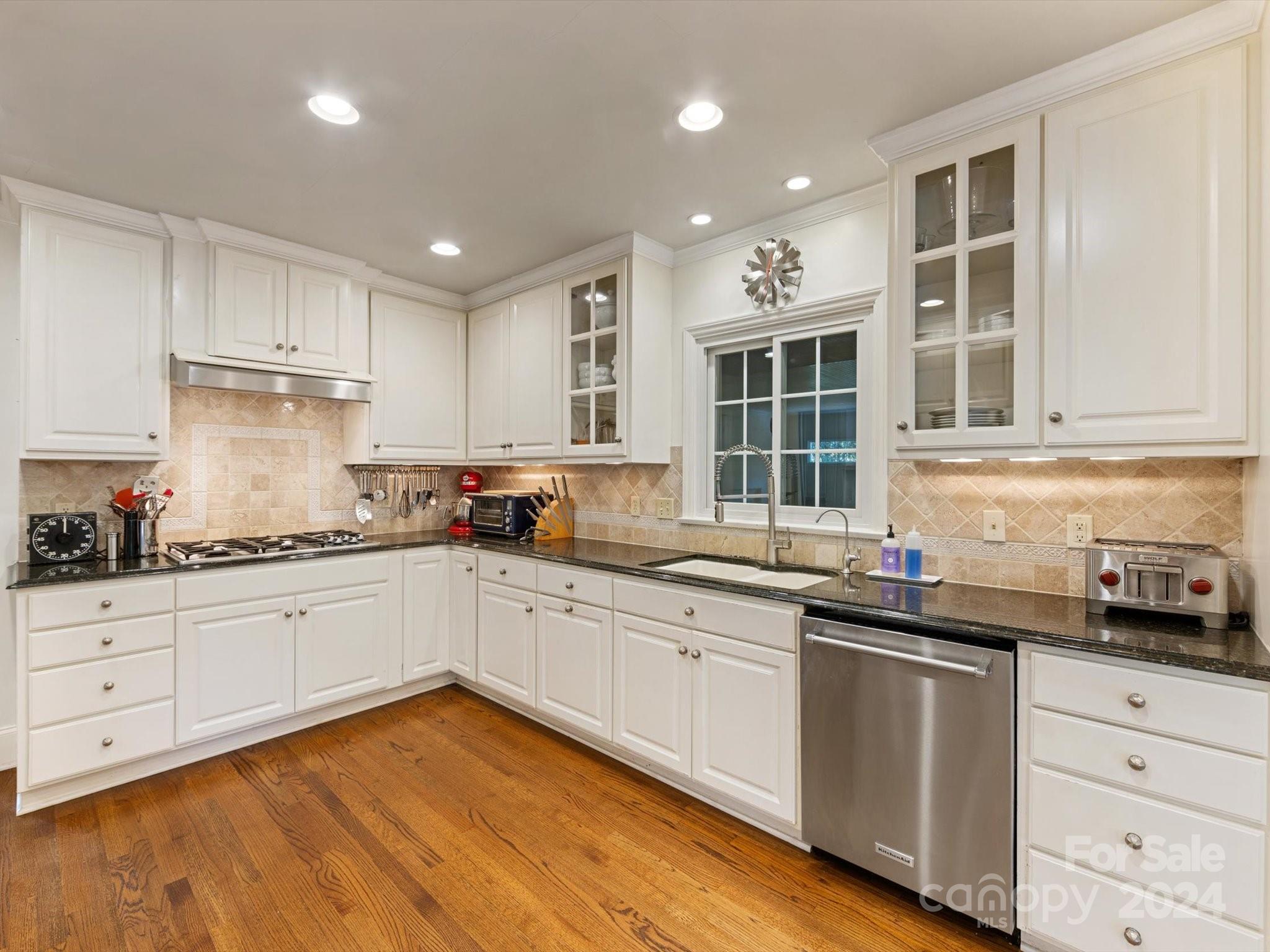 4233 Columbine Circle Charlotte, NC 28211 - Photo 22 of 47 a kitchen with granite countertop white cabinets and white appliances