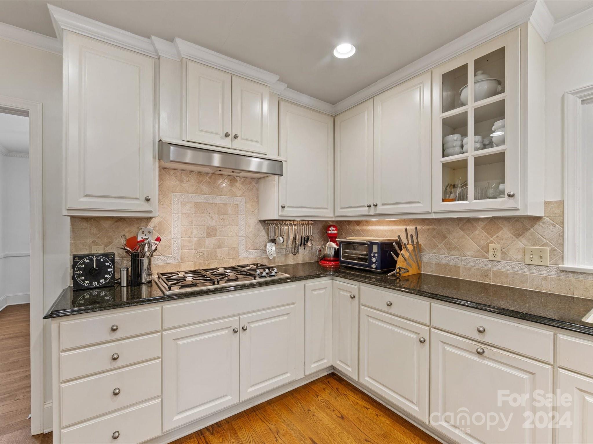 4233 Columbine Circle Charlotte, NC 28211 - Photo 23 of 47 a kitchen with granite countertop white cabinets and white appliances