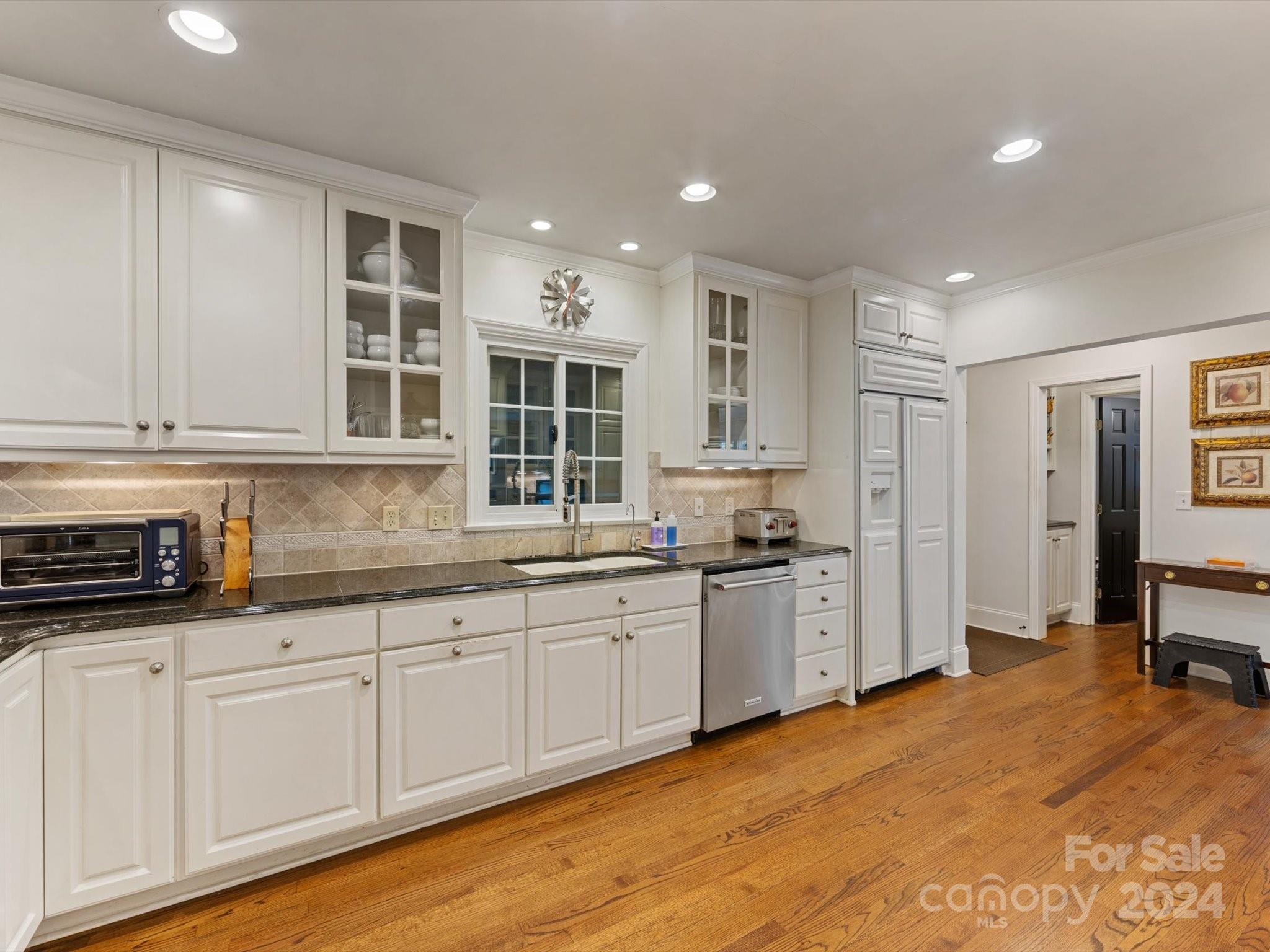 4233 Columbine Circle Charlotte, NC 28211 - Photo 24 of 47 a kitchen with stainless steel appliances granite countertop a stove and a sink