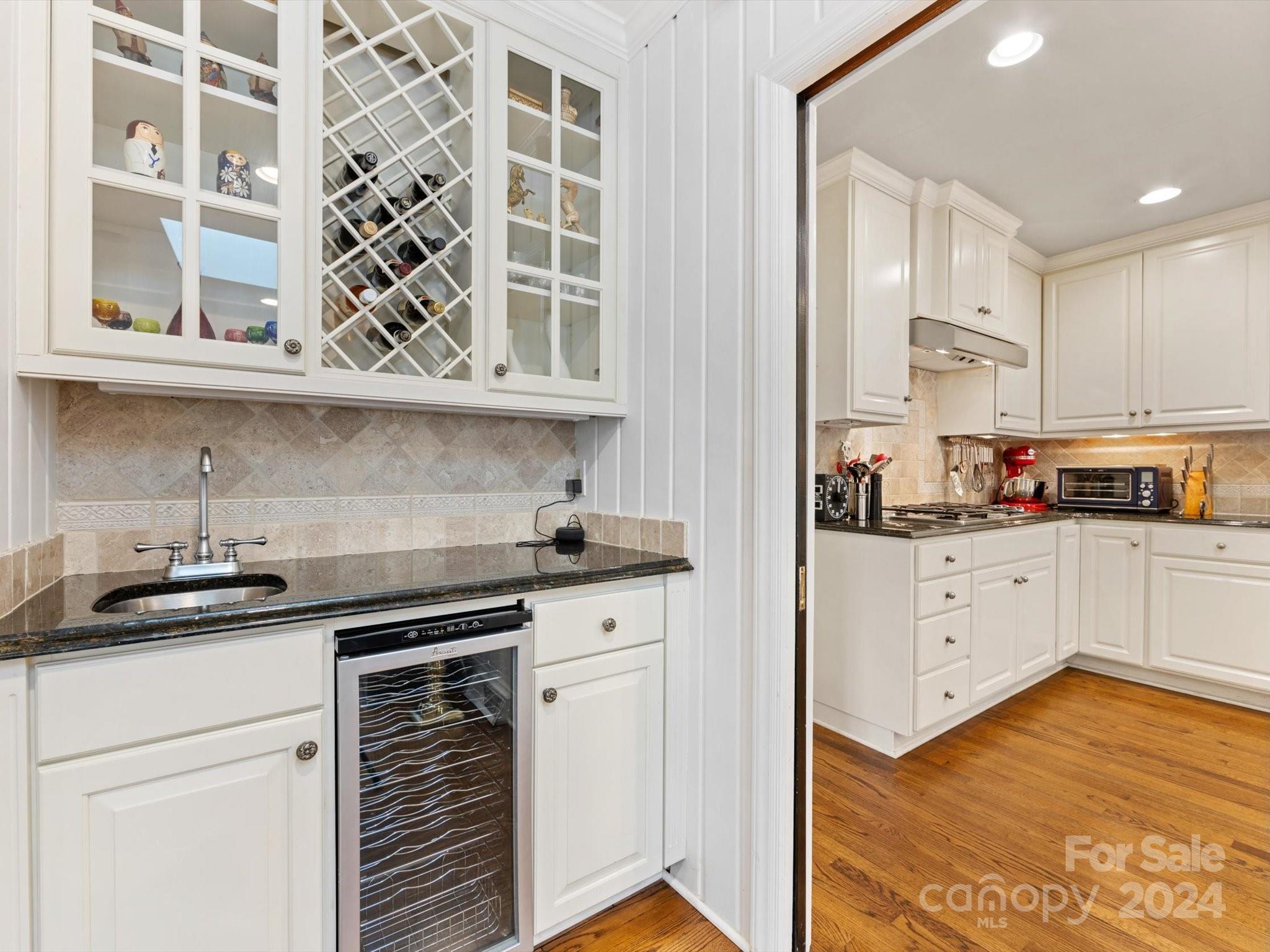 4233 Columbine Circle Charlotte, NC 28211 - Photo 27 of 47 a kitchen with stainless steel appliances granite countertop a sink and cabinets with wooden floor