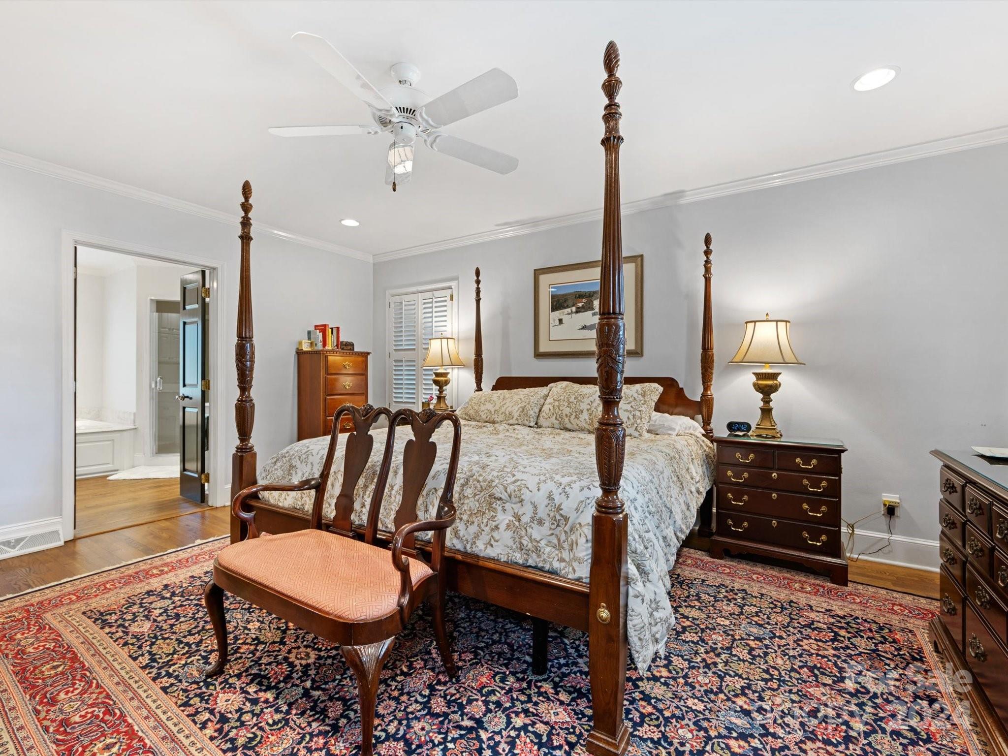 4233 Columbine Circle Charlotte, NC 28211 - Photo 31 of 47 a bedroom with a bed a chandelier and dresser