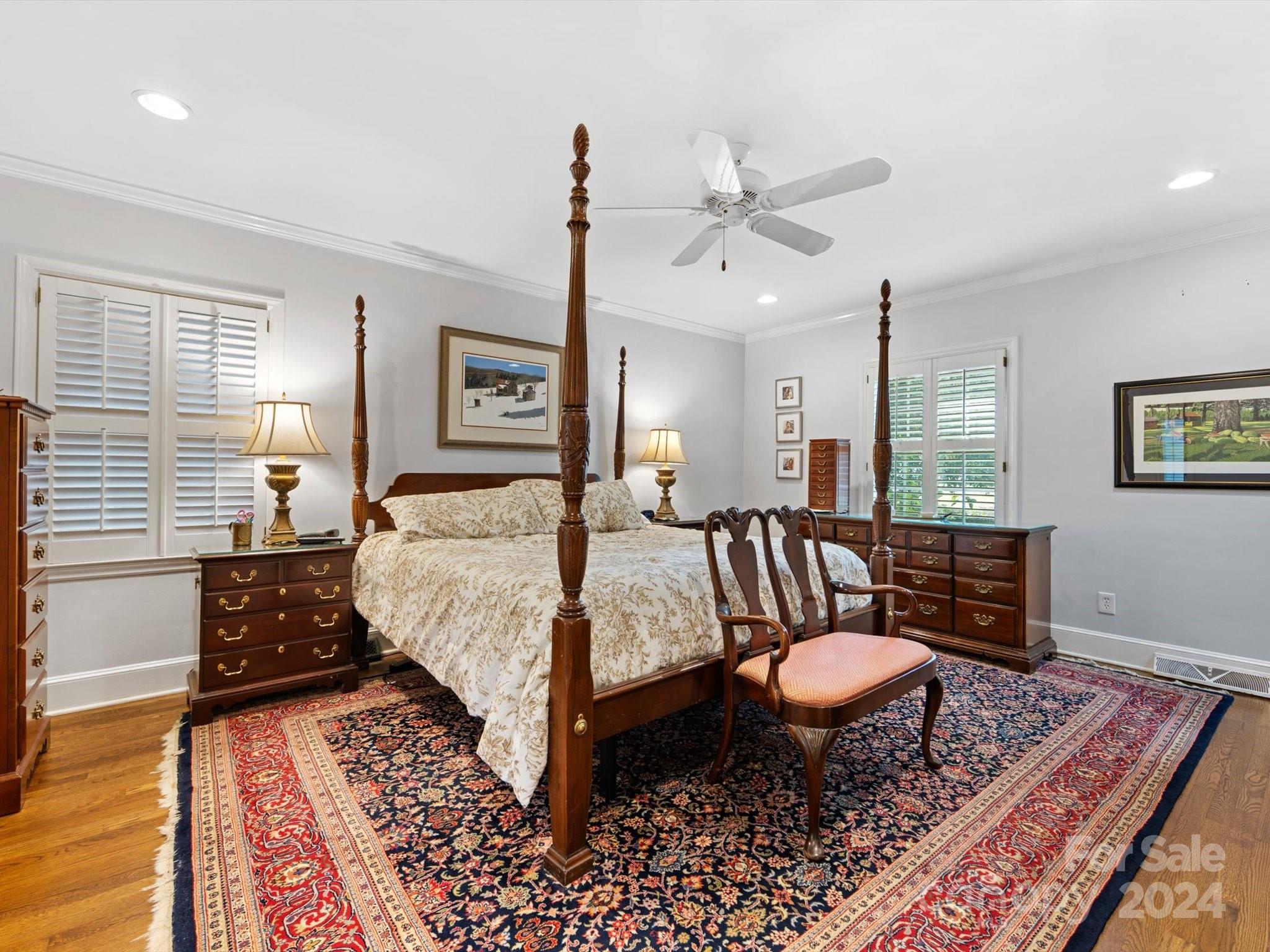 4233 Columbine Circle Charlotte, NC 28211 - Photo 32 of 47 a bedroom with a bed and wooden floor