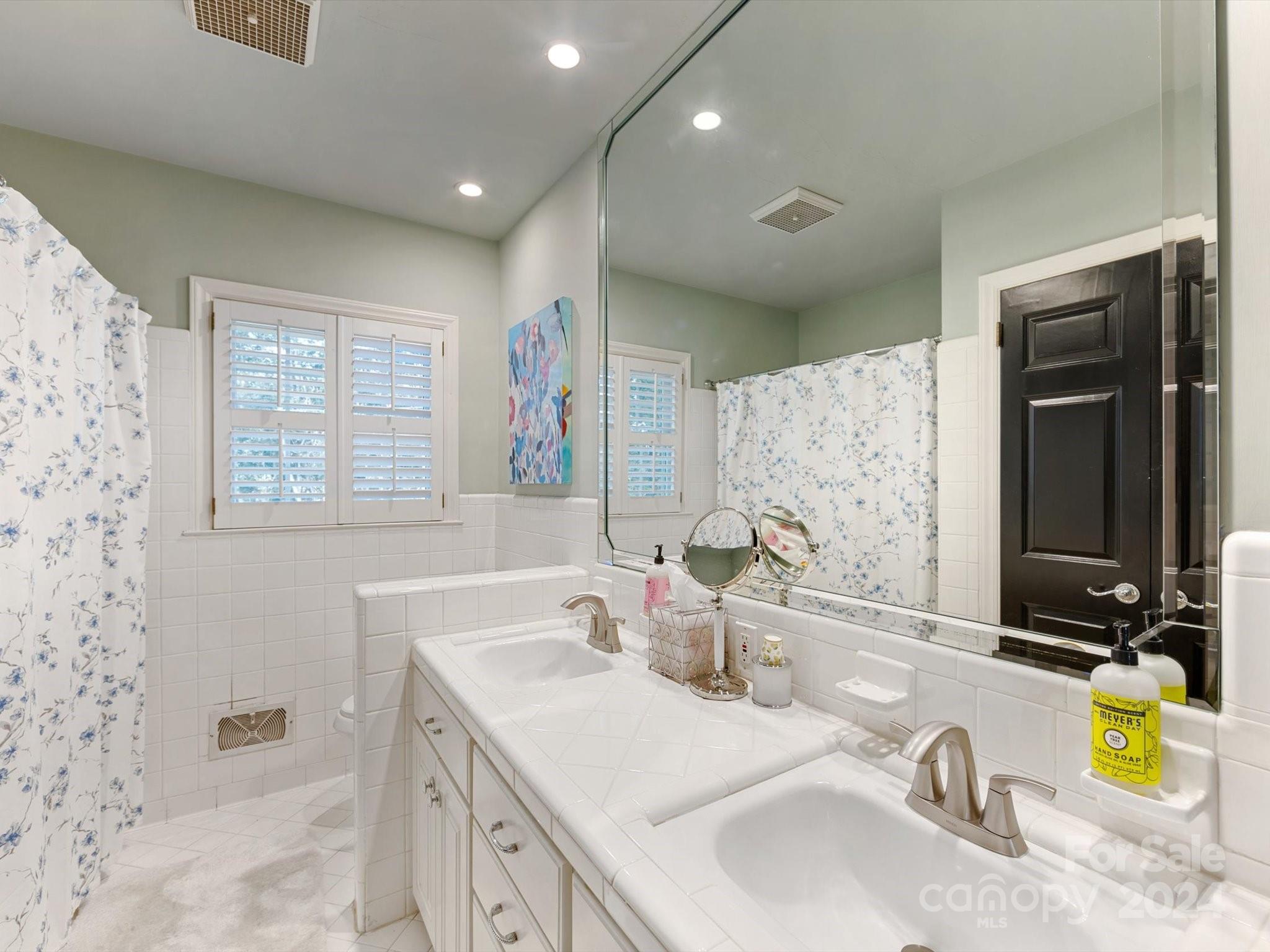 4233 Columbine Circle Charlotte, NC 28211 - Photo 38 of 47 a bathroom with a granite countertop sink and a mirror