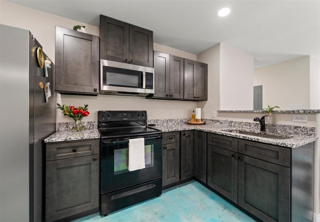 3109 North 27th Street Waco, TX 76708 - Photo 9 of 17 a kitchen with stainless steel appliances granite countertop a stove sink microwave and refrigerator