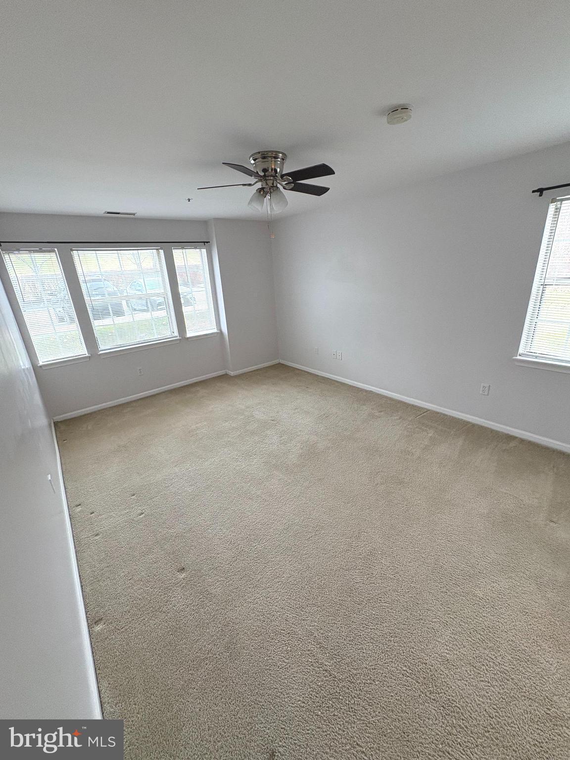 8489 Falls Run Road, Unit A Ellicott City, MD 21043 - Photo 11 of 15 an empty room with windows and fan