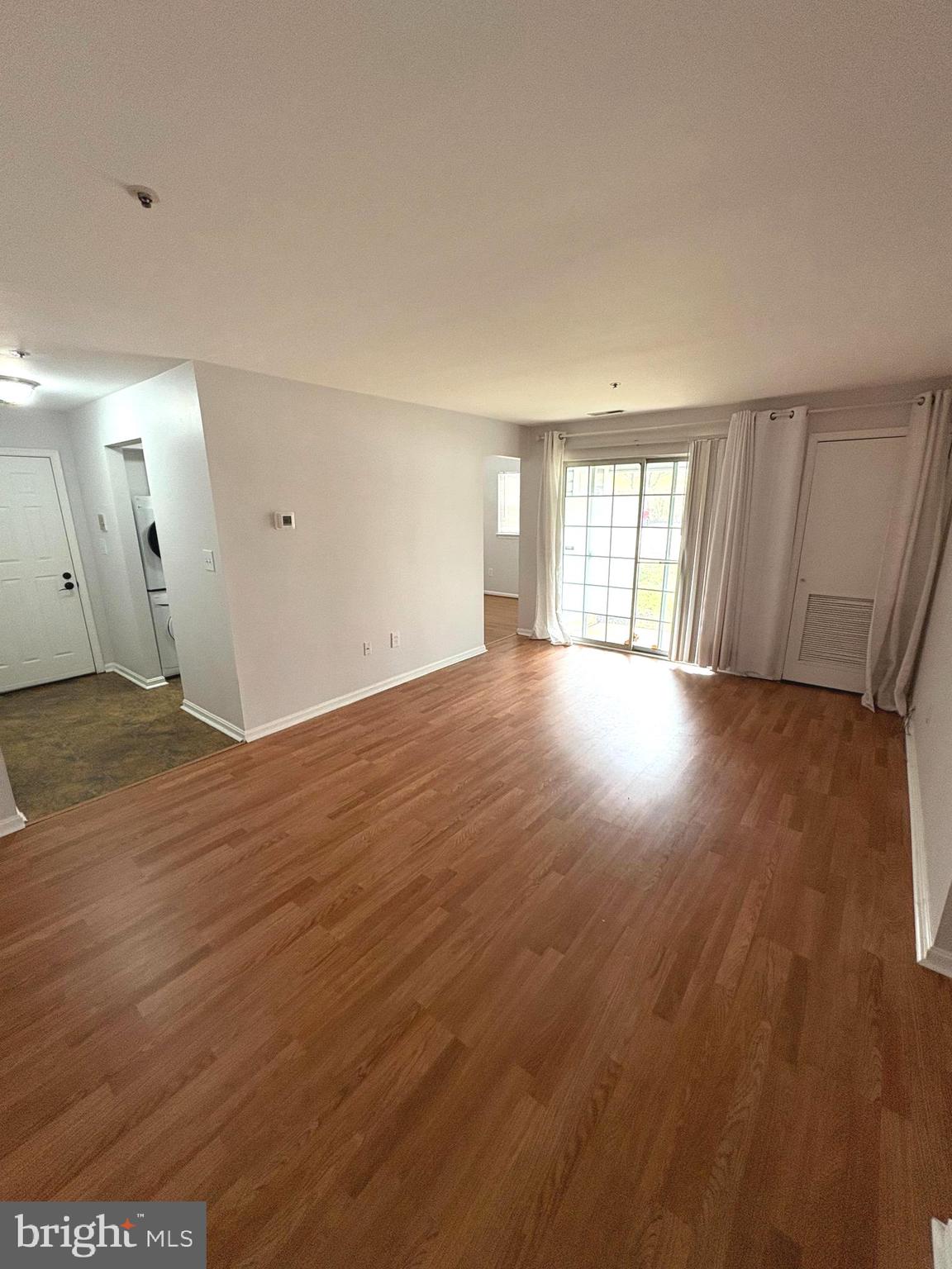 8489 Falls Run Road, Unit A Ellicott City, MD 21043 - Photo 6 of 15 an empty room with wooden floor and windows