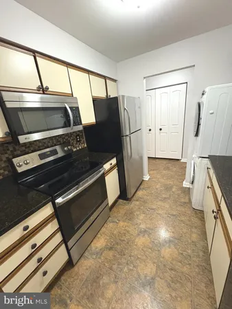 a kitchen with a stove and a refrigerator
