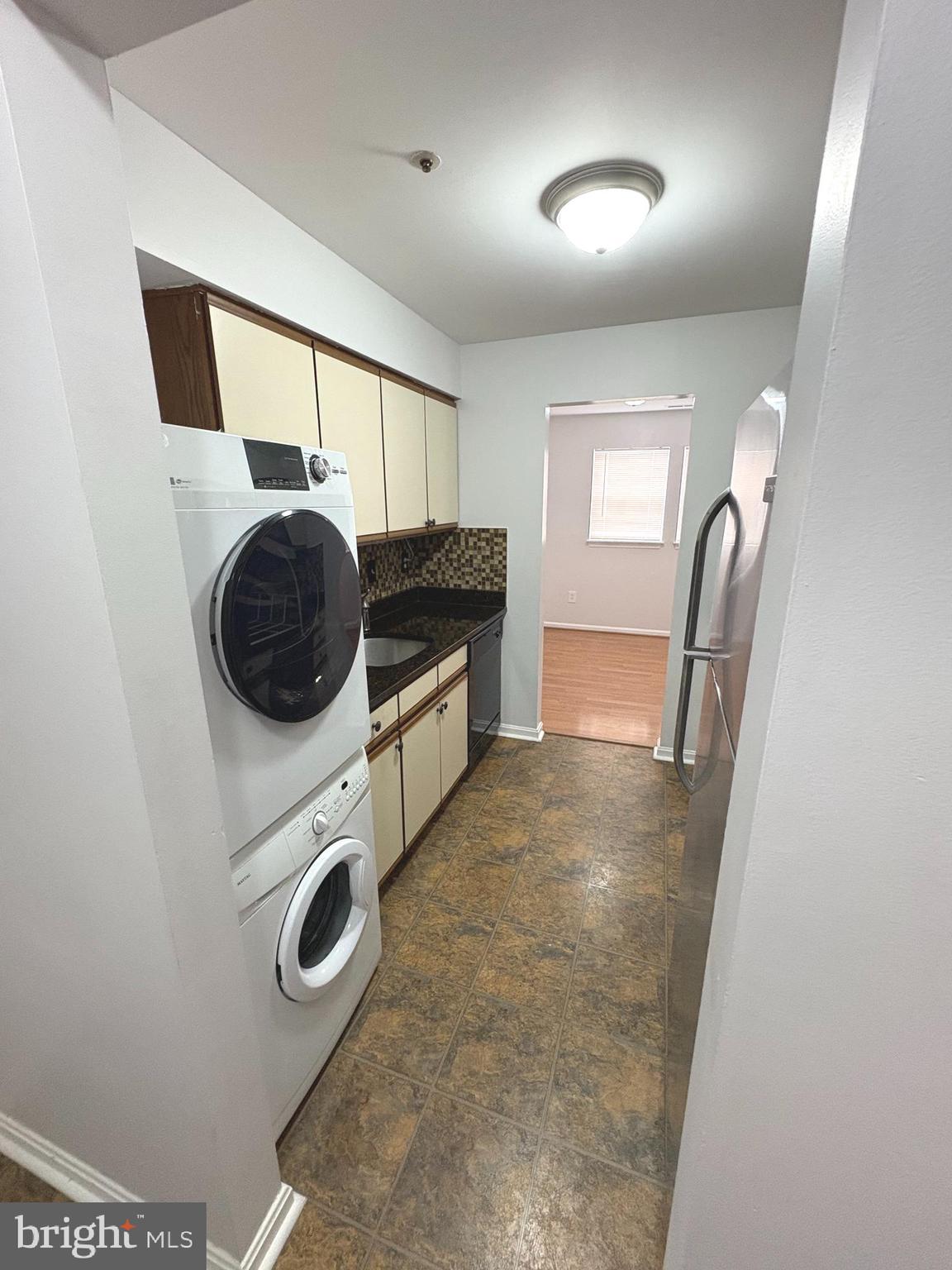 8489 Falls Run Road, Unit A Ellicott City, MD 21043 - Photo 9 of 15 a view of a storage and utility room with washer and dryer