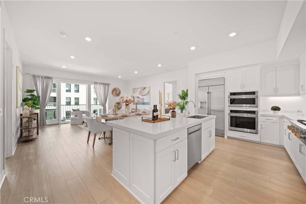 2510 Rivington Irvine, CA 92612 - Photo 13 of 41 a kitchen with stainless steel appliances kitchen island wooden cabinets and center island