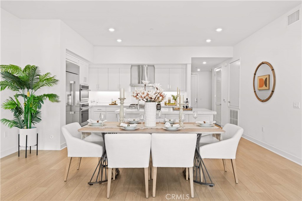 2510 Rivington Irvine, CA 92612 - Photo 16 of 41 a dining room with furniture potted plants and wooden floor