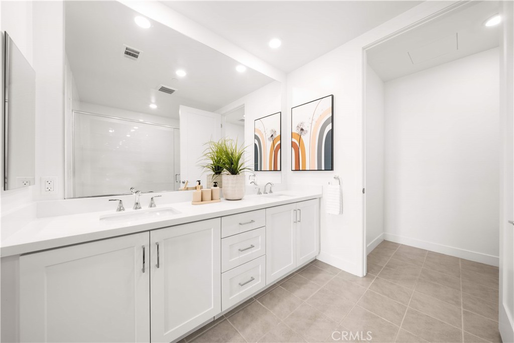 2510 Rivington Irvine, CA 92612 - Photo 20 of 41 a bathroom with a double vanity sink and a mirror
