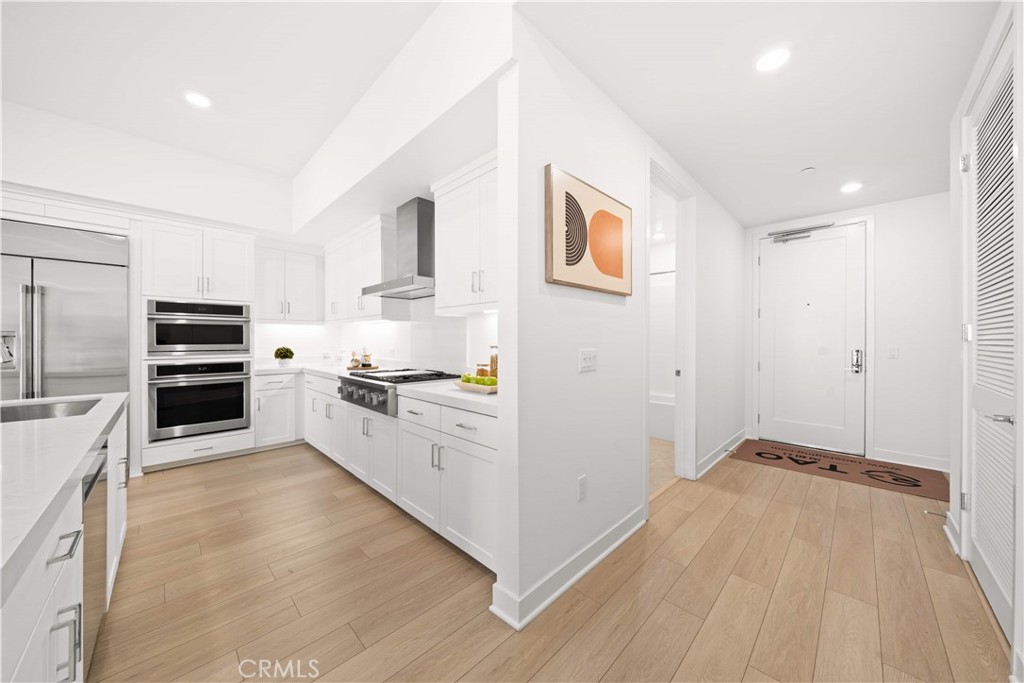 2510 Rivington Irvine, CA 92612 - Photo 9 of 41 a kitchen with cabinets and wooden floor